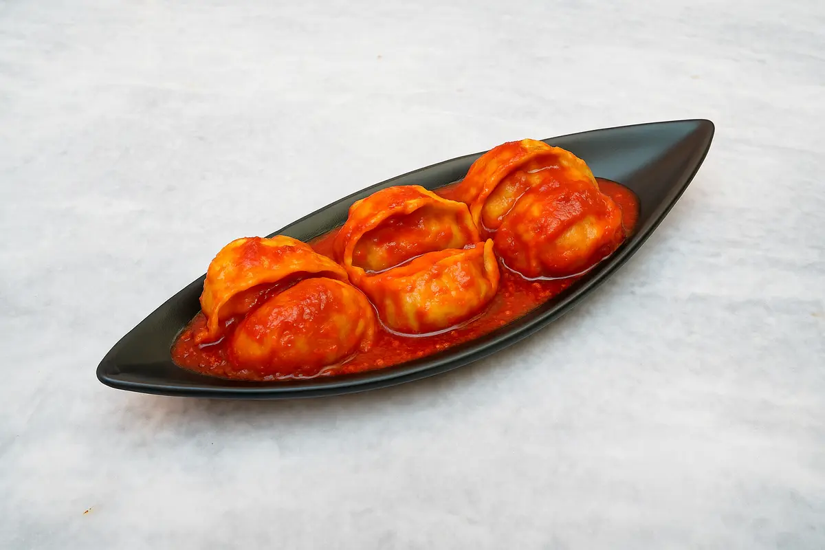 Schezwan Tossed Champaran Chicken Suji Momos